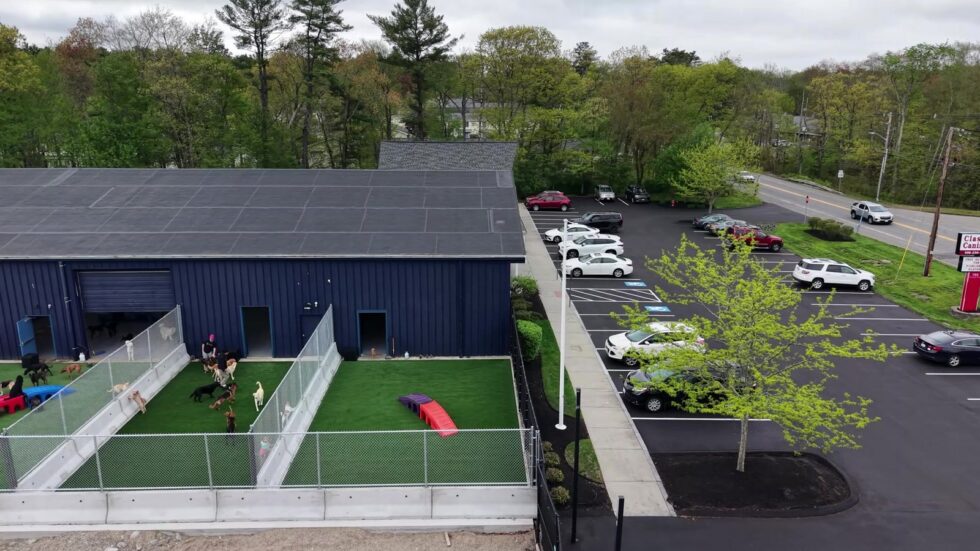 Drone view of the Classie Canines building, dog yards, and parking area